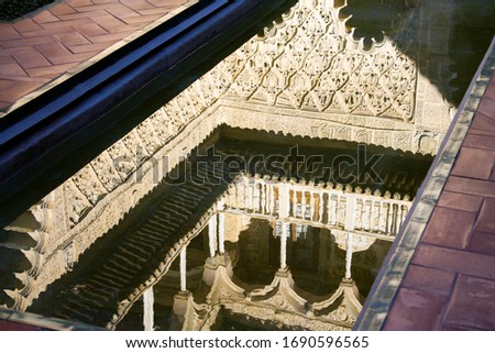A reflection of the Moorish designs in the Patio de Las Doncellas within the Royal Alcázar of Seville (Real Alcázar de Sevilla), the iconic and famous Moorish royal palace. Seville, Andalusia, Spain.