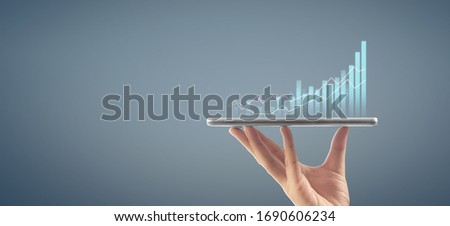 Businessman plan graph growth and increase of chart positive indicators in his business,tablet in hand Royalty-Free Stock Photo #1690606234