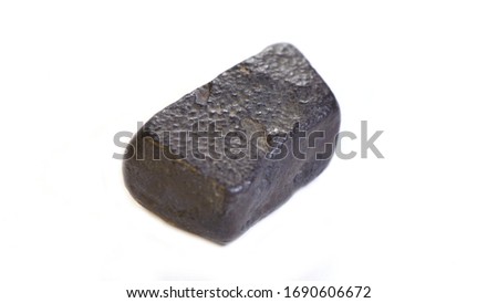 One black meteorite isolated on white backgroundT