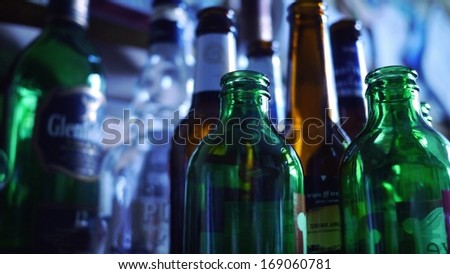 Collection of empty alcohol bottles in several colors ready for recycling.