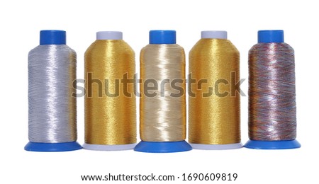  Multicolored objects from the production of industrial and handmade sewing. Thread cones, spools in silver, yellow