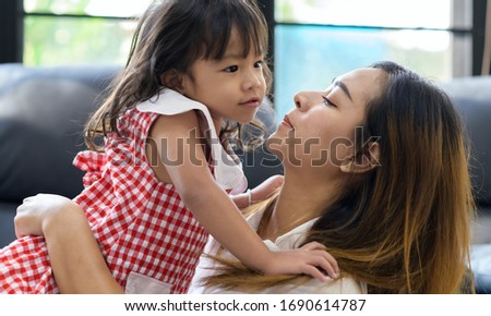 Mother's Day.family. children and happy people concept - happy little girl hugging and kissing her mother