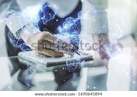 Abstract creative world map and man hand writing in notebook on background, international trading concept. Multiexposure