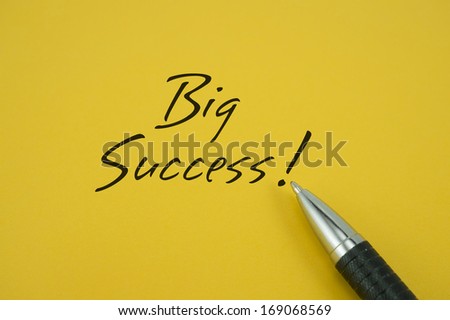 Bgi Success note with pen on yellow background