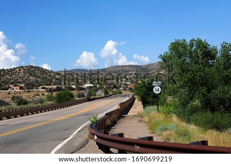 Highway 14, the Turquoise Trail, in New Mexico, can be seen in this image approaching the quiet town of Cerrillos. Royalty-Free Stock Photo #1690699219