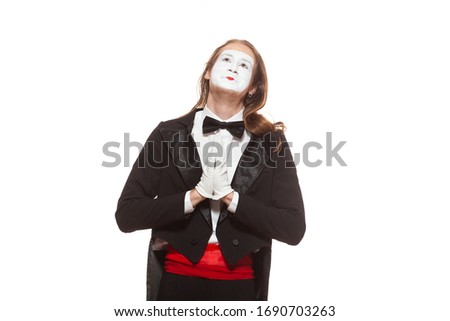 Portrait of male mime artist performing, isolated on white background. Man folded his hands in prayer. Symbol of hope, gratitude, religion