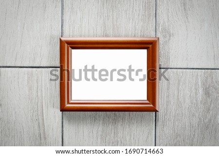Blank Picture frame on wooden floor.