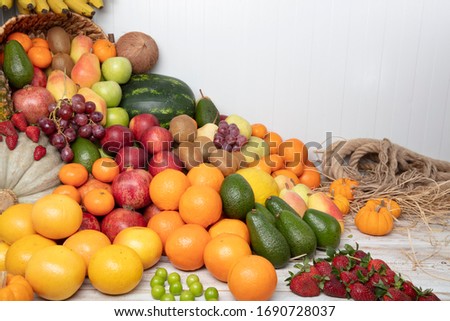 Fruit in the Shooting various fruits in the studio: tangerines, pomegranate, orange, apple, pear, grape, mango,  ... all Arranged on shelves look attractive and eye-catching.