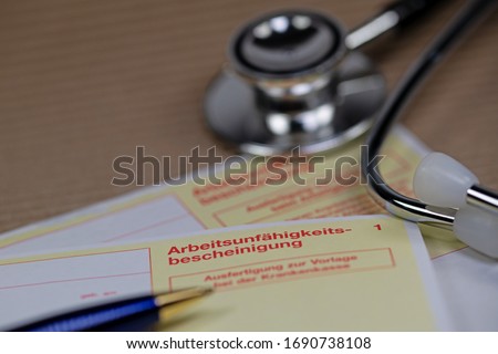 Health certificate and stethoscope with the German text Arbeitsunfähigkeitsbescheinigung - unable to work Royalty-Free Stock Photo #1690738108