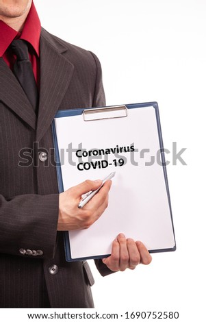 Businessman point to coronavirus text