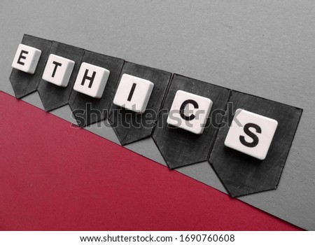 Ethics, word cube with background.