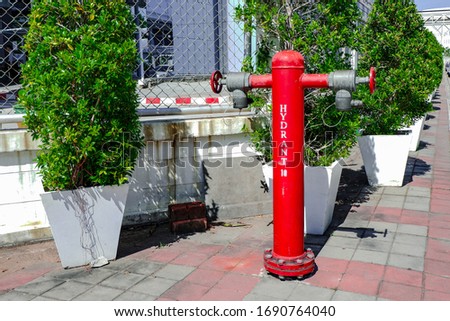 Hydrant system. Water supply with pressure through red pipes system for fire-fighting purposes.