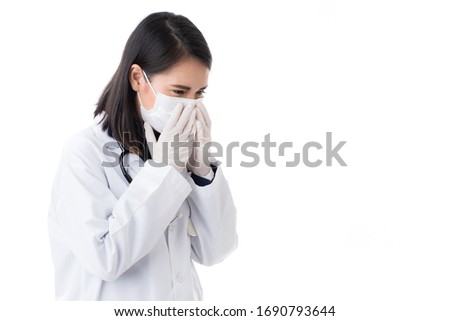 Beautiful woman doctor in lab coat dress wearing surgical hygiene protective mask sneezing and using hands cover face, nose and mount. Asian woman medical people cough, isolated white background.