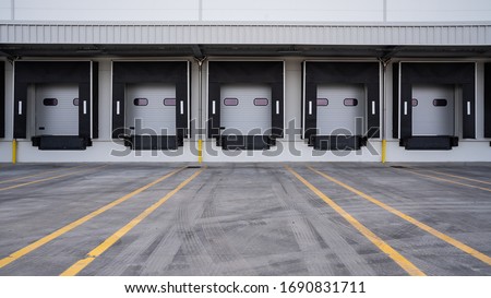 Row of loading docks. Warehouse building. Royalty-Free Stock Photo #1690831711