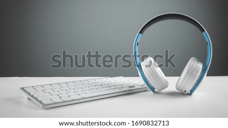 White headphones with a computer keyboard. Business desk
