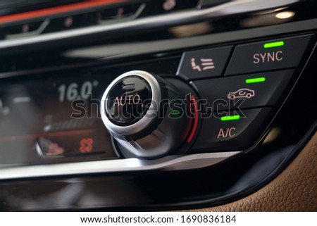 Selective focus of Vehicle Air Conditioning Control System. AC Recirculation Button on dashboard in luxury car. Royalty-Free Stock Photo #1690836184