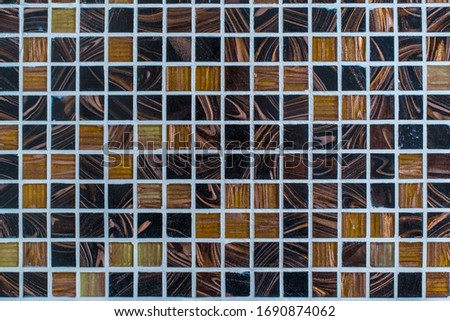 Texture and geometric pattern, pattern of a fashionable and expensive bathroom made of brown decorative mosaic and smalt.