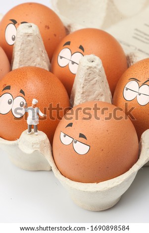 Chefs, in front of a box of eggs with eyes, isolated on a white background