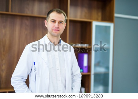 Portrait of a smiling doctor. Male medical specialist. Surgeon or radiologist, on medical room background.