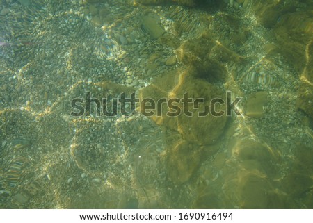 background sand of the sea beach through clear transparent water 
