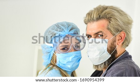 coronavirus pandemic outbreak preventions. stay at home. man and doctor in respirator mask. Couple in love. protect your family. quarantine. nurse woman hug patient. avoid personal contact.