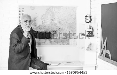Formal education. Classic subjects learning. Improve teaching skills. Main task in teaching. Knowledge and culture are each dynamic. Teaching changed. Man bearded tutor in classroom. Mature pedagogue. Royalty-Free Stock Photo #1690954453
