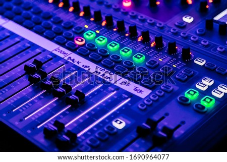 Close up of sliders and button on Audio Mixing Desk at live event Royalty-Free Stock Photo #1690964077