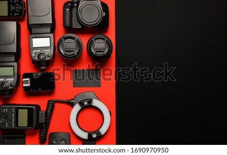 Modern photographer's equipment with card on color background