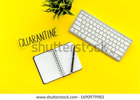 Quarantine home office. Notebook and keyboard on yellow background top view