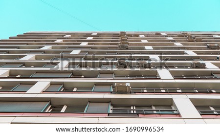 High rise residential building with Windows of residential apartments and air conditioning under a clear blue sky on a Sunny day. Modern district in the city. The concept of buying a quart.