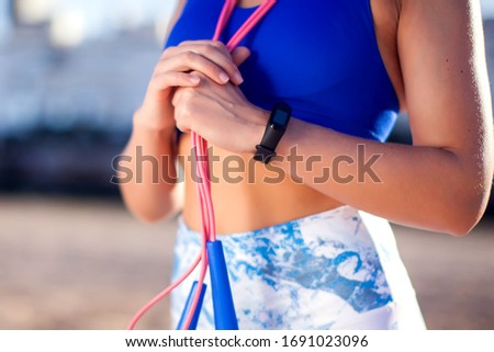 Woman training with jump rope outdoor. Close up. People, fitness and healthcare concept