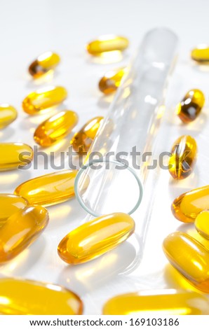Research for better health. Test tube with fish oil gel tabs.