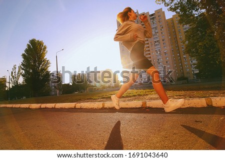 young beautiful girl athlete jogging. beautiful girl athlete is engaged in jogging. morning running. healthy sport lifestyle concept. young girl goes in for sports. vintage photo processing