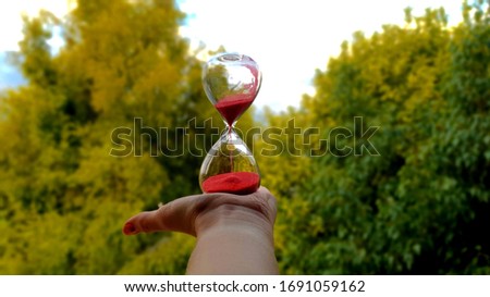 Hourglass to the skies, time is the only certain thing  Royalty-Free Stock Photo #1691059162