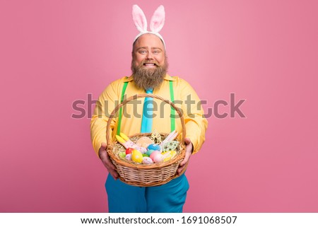 Portrait of his he nice friendly careful funky glad bearded guy giving you festal Easter handmade basket congratulating isolated over pink pastel color background