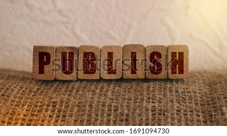 Publish word written on wooden blocks. Content publishing ad or education concept.