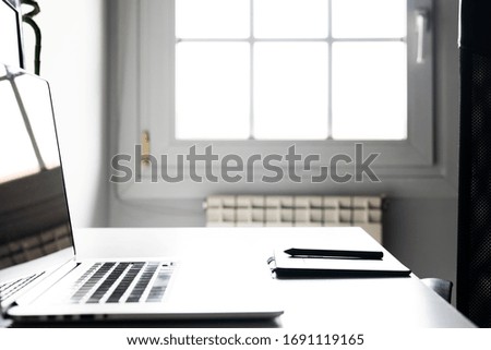 Home workspace with laptop and graphics tablet.