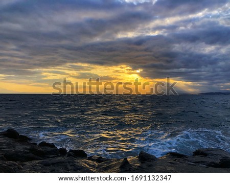 Light cloudy sky and colorful dramatic sunset sky over the sea from stone coast.  Shade color of twilight sky atmosphere in holiday and relaxing day time.Natural harmony background at Enoshima, Japan.