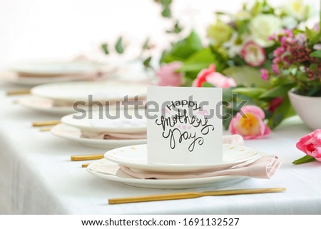 Table setting with card for Mother's day dinner Royalty-Free Stock Photo #1691132527