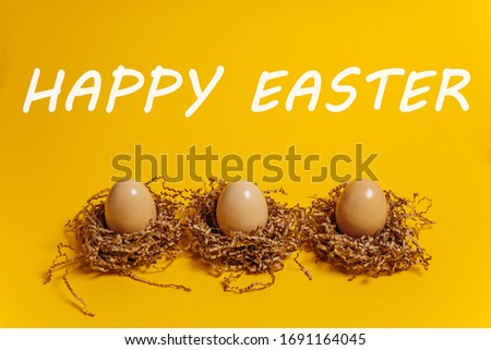 Happy easter. Three eggs on a yellow background. Chicken eggs on a sheet of corrugated kraft paper. Eco-friendly farm food from the village. Greeting card. Easter theme.