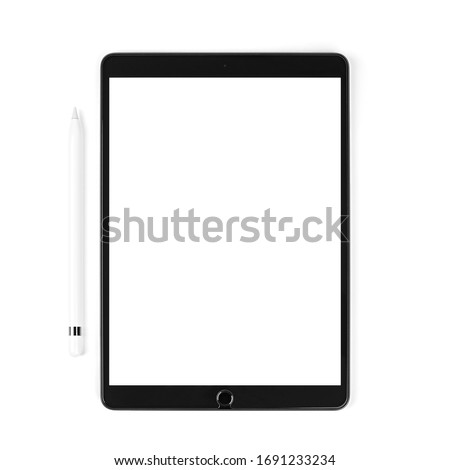 Modern device the tablet with white stylus on isolated light background. Black tablet computer with blank screen, isolated on white background. Technology Concept.  Royalty-Free Stock Photo #1691233234