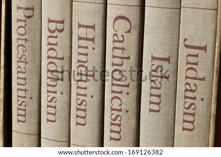 Book spines listing major world religions - Judaism, Islam, Catholicism, Hinduism, Buddhism and Protestantism. Royalty-Free Stock Photo #169126382