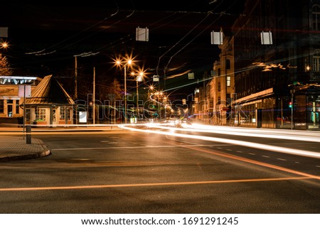 Long exposure photo at night. Light trails on the road. City street.