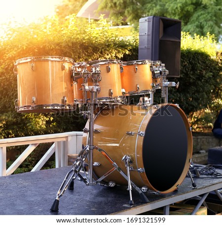 Yellow drum set on nature. Professional drums for concert playing. Scene with bass reproduction tool