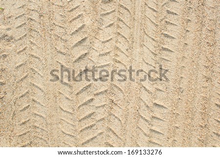 Detail of tyre tracks in sand desert Royalty-Free Stock Photo #169133276