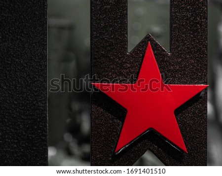 The red five-pointed metal star is a symbol of the Soviet Union and the Soviet Army, a close-up Soviet star, Symbol of Victory in the Second World War