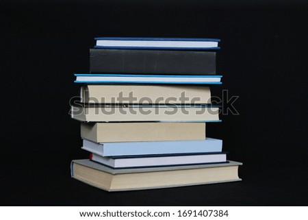 Student books on a black background at the time of the coronavirus