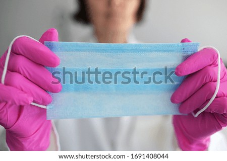 Medical Nurse Or Doctor Putting On The Protective Mask