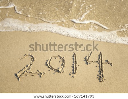 New Year 2014 is coming concept-New Year 2014 written in sand on the beach
