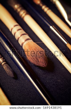 Paintbrushes on a black table.